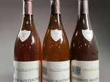 three bottles of wine sitting on top of a table next to each other