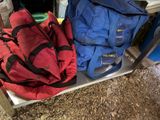 two bags sitting on a shelf next to each other