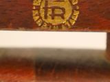 a close up of a wooden bench with a gold emblem on it