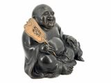 statue of a laughing buddha holding a wooden paddle on a white background