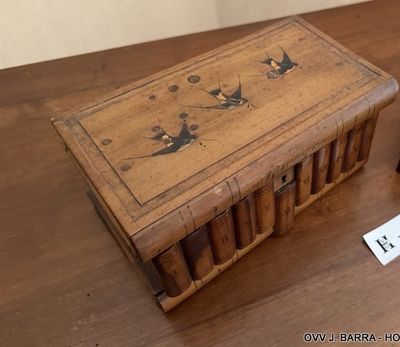 a wooden box with a picture on it sitting on a table
