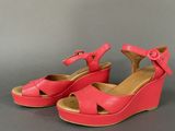 pink wedged sandals with a bow on the heel and a heel strap