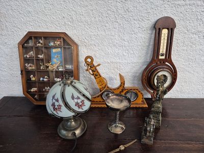 a wooden table topped with a clock and a clock on it