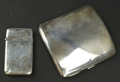 two silver lighters sitting next to each other on a table