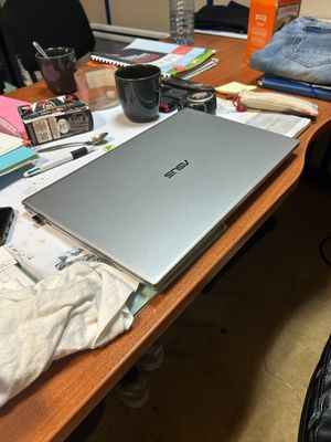 a laptop computer sitting on top of a wooden desk