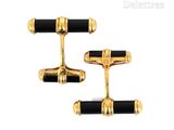 two pairs of black and gold cufflinks with gold accents