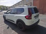 a white car that is parked on the side of the road