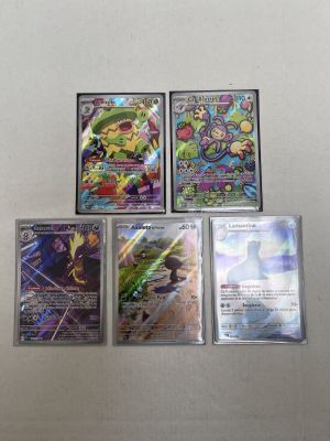four different pokemon cards sitting on top of each other on a table