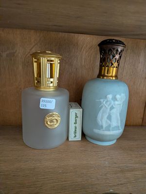 deux flacons de parfum posés l'un à côté de l'autre sur une étagère