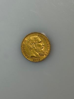 a gold coin sitting on top of a white table