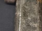 a silver lighter that is sitting on a table