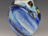 a blue and white vase that is sitting on a table