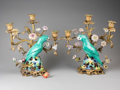 deux oiseaux bleus perchés sur une branche ornée de fleurs