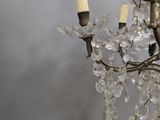 a glass chandelier with a bunch of crystal beads hanging from it