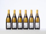 six bottles of white wine lined up in a row