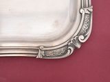 a silver tray on a table with a red background