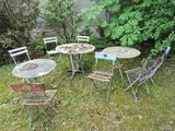 four chairs and a table in the grass outside