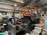 a large machine that is in a factory with lots of machines