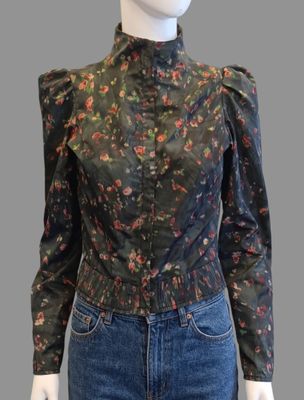 a mannequin mannequin wearing jeans and a floral blouse