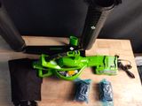a green leaf blower sitting on a table next to other items