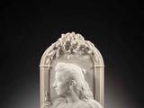 a white marble bust of a woman with flowers in her hair