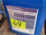 a blue plastic container with a red cap on top of a pallet
