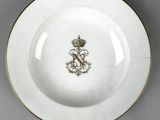 an image of a white plate with a gold rim and a crown on it