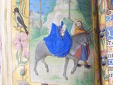 an open book with a picture of a woman riding a donkey