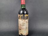 a bottle of wine with a red cap on a black background