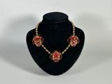 a necklace and earring set on a mannequin display