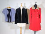 three coats on a mannequin stand in a white room