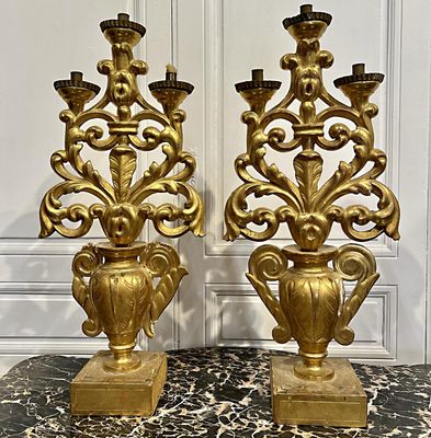 deux vases dorés posés sur une table en marbre
