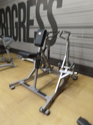 a gym room with a wall that has progress written on it