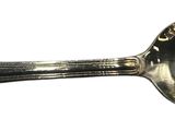 a spoon that is sitting on a white surface