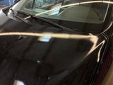 a black car that is parked in a garage
