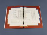 un livre ouvert sur lequel figure une liste, posé sur une table