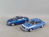 two toy cars sitting next to each other on a table