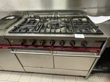 a stainless steel stove with four burners in a kitchen