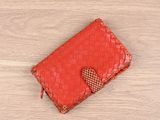 red woven leather wallet with a heart on the front