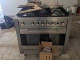 a stove with a box on the floor next to it