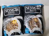 two bags of fish food sitting on top of a counter