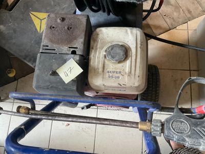 an image of a man using a power washer to clean the floor