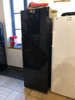 an image of a kitchen with a refrigerator and a window