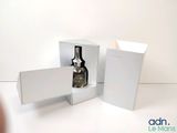 someone is taking a picture of a bottle of alcohol in a box