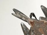 a close up of a pair of scissors with writing on them