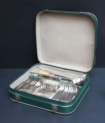 a green case with silverware in it on a table