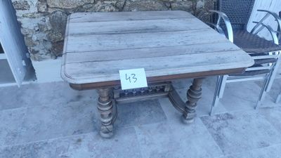 a wooden table and two chairs on the patio
