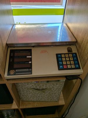 a calculator sitting on top of a shelf in front of a window
