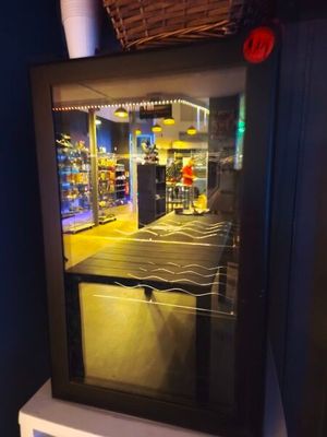 a picture of a reflection of a person in a store