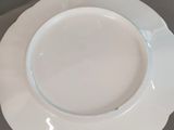 a white plate sitting on top of a table next to a bowl